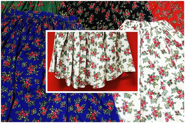 Zdjęcie strojów ludowych. Spódnice w kwiaty w różnych kolorach.